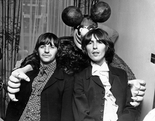 Ringo Starr and George Harrison pose with a Blue Meanie from their film Yellow Submarine on July 8, 1968 in London.