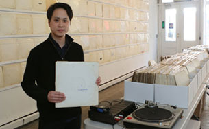 The artist Rutherford Chang at his installation “We Buy White Albums” at Recess Gallery. (Photo by Chester Higgins Jr./The New York Times)