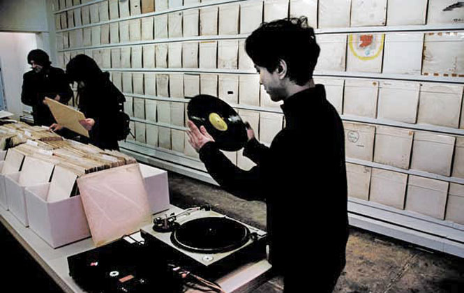 Rutherford Chang recording one of the hundreds of “White Album”s from his collection for a master disc he’s creating.