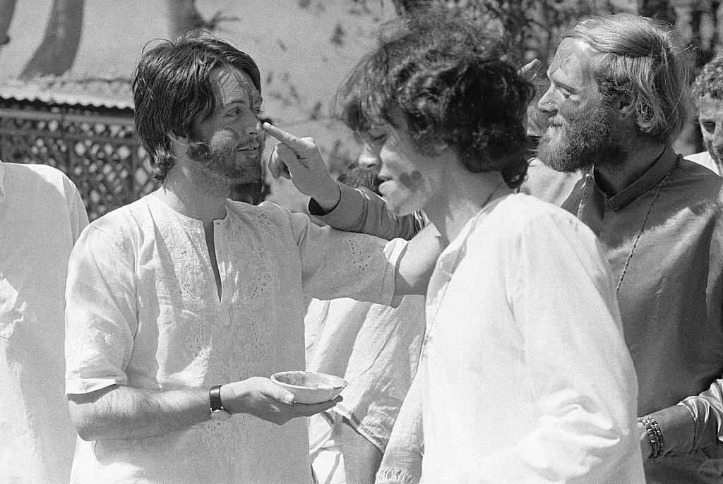 Paul McCartney, Donovan, and Mike Love painting faces. (1968)